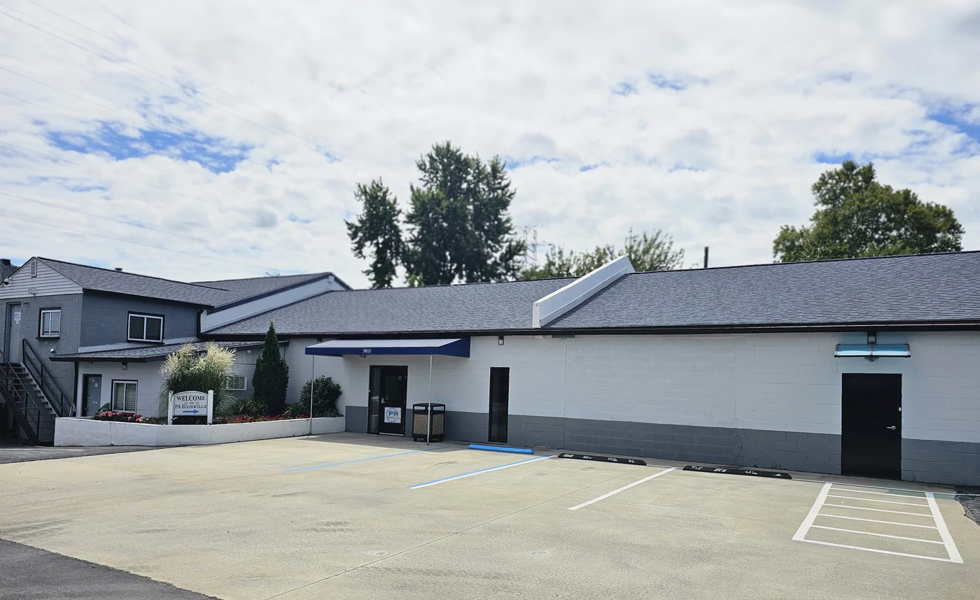 Building exterior — front with parking